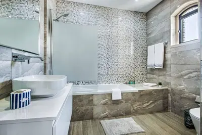 a bathroom with a tub and a sink at Villa Marquesa in Guia