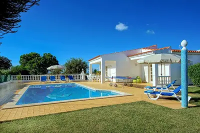 a villa with a swimming pool and a house at Villa Licinia in Guia