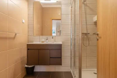 a bathroom with a sink and a shower at Jardins Marina Stars in Albufeira