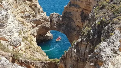 a group of people in a boat in the water at Jardins Marina Stars in Albufeira