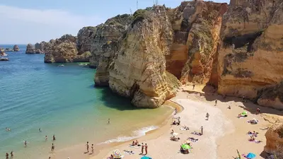 a group of people on a beach near the ocean at Jardins Marina Stars in Albufeira