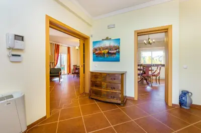 a living room with a tiled floor at Villa Amarela in Boliqueime