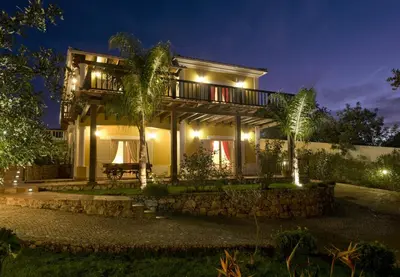 a house at night with lights at Villa Amarela in Boliqueime