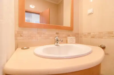 a bathroom with a white sink and a mirror at #004 Orada by Home Holidays in Albufeira