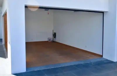 an open garage door with a basketball court at Amora Villa - Vilamoura in Vilamoura