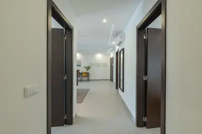 a hallway with doors open to a hallway with a table at VERASOL 3 in Albufeira