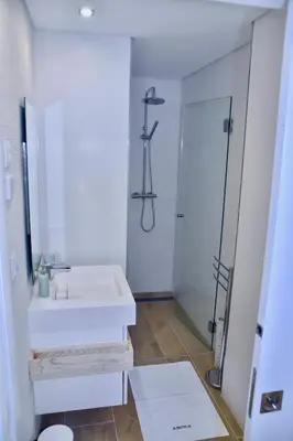 a bathroom with a white sink and a shower at Amora Villa Sacha in Vilamoura
