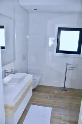 a white bathroom with a sink and a toilet at Amora Villa Sacha in Vilamoura