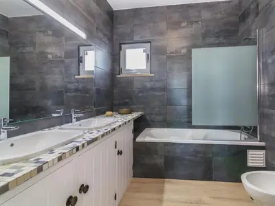 a bathroom with two sinks and a tub at Villa Arribas Villa by Interhome in Patroves