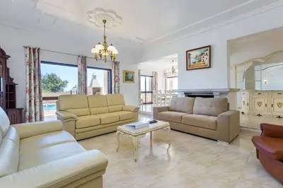 a living room with two couches and a table at Villa Mirante in Albufeira