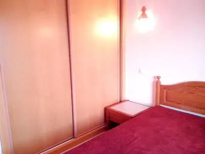 a bedroom with a bed with a red bedspread at Welcoming apartment in Albufeira 80 m² with shared pool in Albufeira