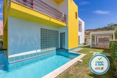 a house with a swimming pool in front of it at Villa 14 Marina de Albufeira in Albufeira