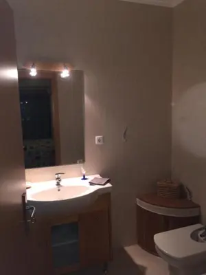 a bathroom with a sink and a toilet and a shower at Oasis in Olhos de Agua in Branqueira