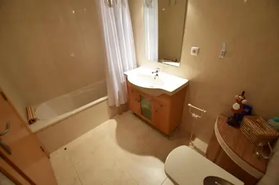 a bathroom with a sink and a toilet and a tub at Oasis in Olhos de Agua in Branqueira