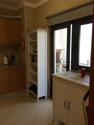a kitchen with a white refrigerator next to a window at Apt 2 Quartos, BBQ, AC, Varanda, Prestige For Home in Quarteira