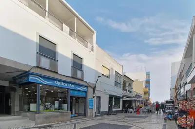 an empty street in a city with buildings at Apt 2 Quartos, BBQ, AC, Varanda, Prestige For Home in Quarteira