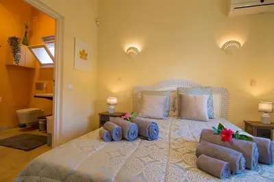 a bedroom with a bed with three pillows on it at villa yvonne,private pool,private parking 1,7 km from the beach in Albufeira