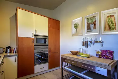 a kitchen with a wooden cabinet and a counter at villa yvonne,private pool,private parking 1,7 km from the beach in Albufeira