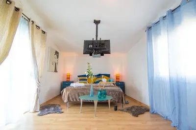 a bedroom with a bed and a table in it at villa yvonne,private pool,private parking 1,7 km from the beach in Albufeira
