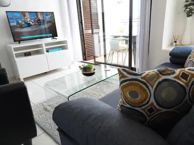 a living room with a couch and a tv at Sea View 3 in Albufeira