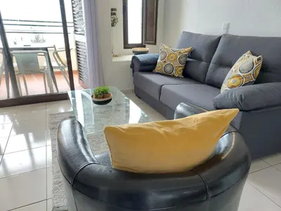 a living room with a couch and a glass table at Sea View 3 in Albufeira