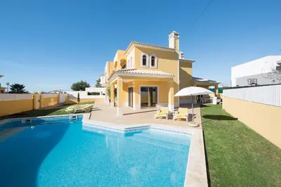 a villa with a swimming pool in front of a house at Villa Lote 7 by Gabi Miguel in Guia
