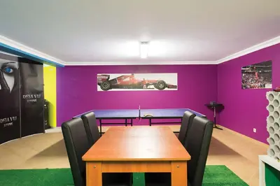 a dining room with a table and a purple wall at Villa Lote 7 by Gabi Miguel in Guia