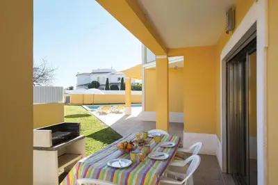 a table with plates of food on it on a balcony at Villa Lote 7 by Gabi Miguel in Guia