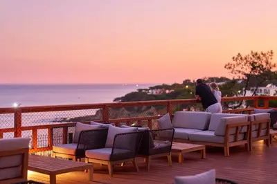 a person holding a bowl of food and a drink at PortoBay Blue Ocean in Albufeira