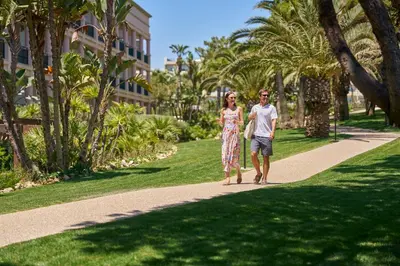 a man and a woman walking down a path at PortoBay Blue Ocean in Albufeira