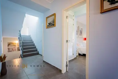 a hallway with a staircase leading to a bedroom at Villa Oriente - Greice Homes in Vilamoura