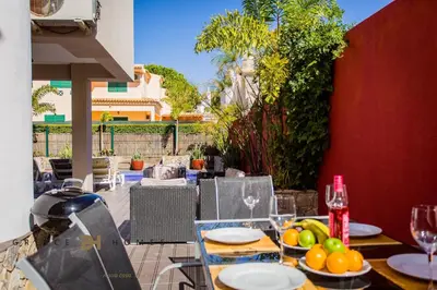 a table with plates of fruit on a patio at Villa Oriente - Greice Homes in Vilamoura