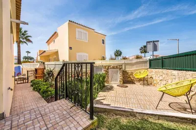 a house with a fence and a patio at Villa Simoes in Guia