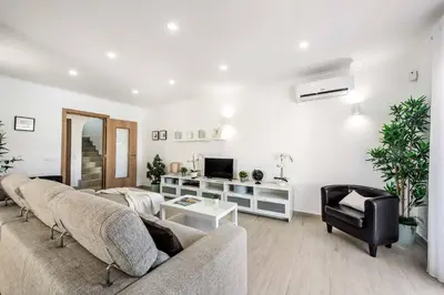 a living room with two couches and a tv at Villa Simoes in Guia