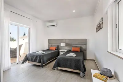 a bedroom with two beds and a window at Villa Simoes in Guia