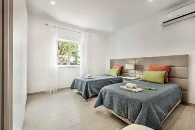 a bedroom with two beds and a window at Villa Simoes in Guia