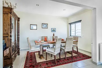 a dining room with a table and chairs at Villa Sao Joao in Caliços