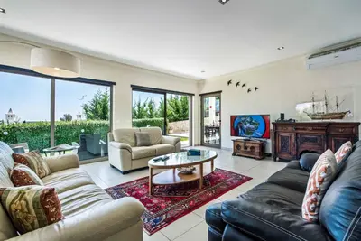 a living room with a couch and a table at Villa Sao Joao in Caliços