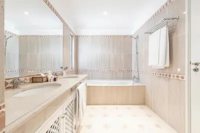 a bathroom with a sink and a tub and a shower at Encosta Do Lago Resort Club in Quinta do Lago