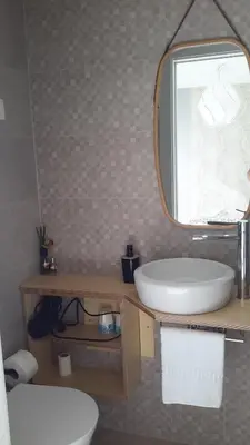 a bathroom with a glass shower and a sink at Villas Sol e Poesia in Albufeira