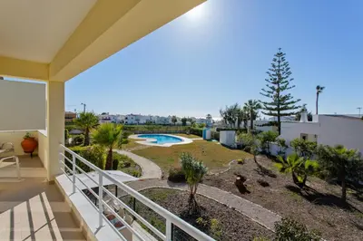 a balcony of a house with a swimming pool at Villas Sol e Poesia in Albufeira