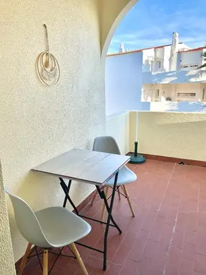 a table and two chairs sitting on a patio at Apartamento bem localizado in Albufeira