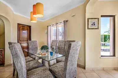 a dining room with a glass table and chairs at Villa Charlota in Albufeira