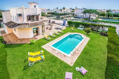 an aerial view of a house with a swimming pool at Villa Charlota in Albufeira