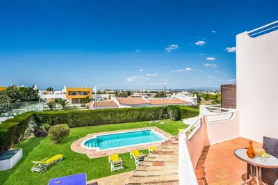 a view from the balcony of a house with a swimming pool at Villa Charlota in Albufeira