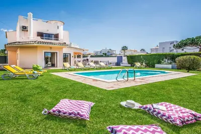 a house with a swimming pool in the yard at Villa Charlota in Albufeira