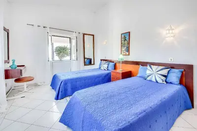 a bedroom with two beds and a window at Villa Brigida in Albufeira