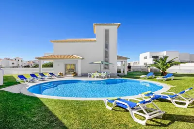 a yard with chairs and a pool and a house at Casa Ferrero in Guia