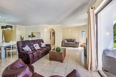 a living room with a couch and a table at Villa Miramar in Albufeira