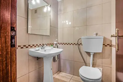 a bathroom with a toilet and a sink at Villa Miramar in Albufeira